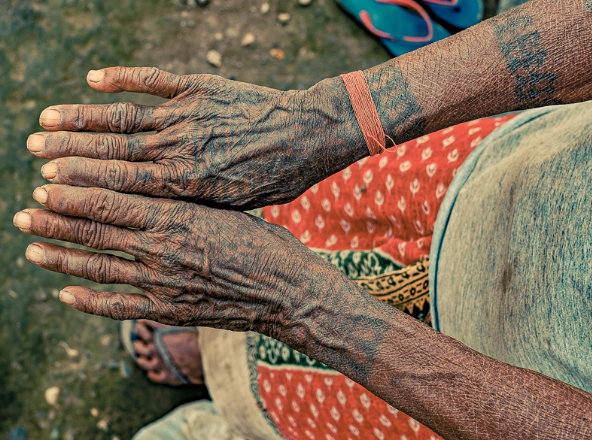 Tharu women with hand tattoos known as godna art in tharu culture